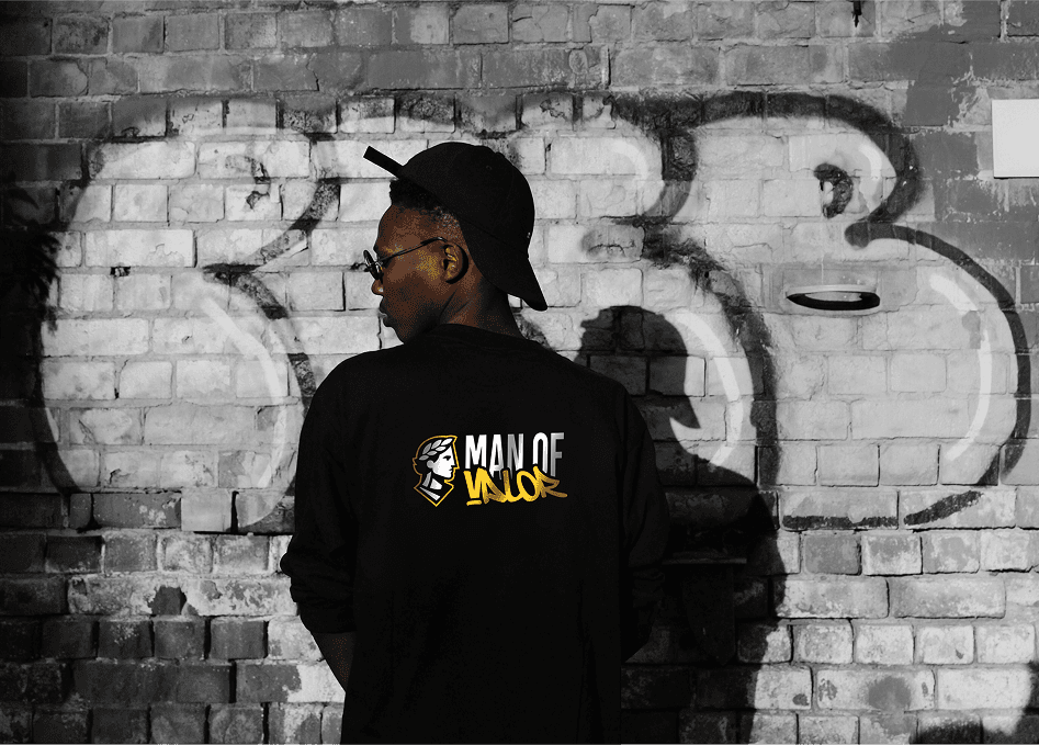 A stylish green armchair next to a modern lamp, set against a dark wall for a cozy atmosphere.