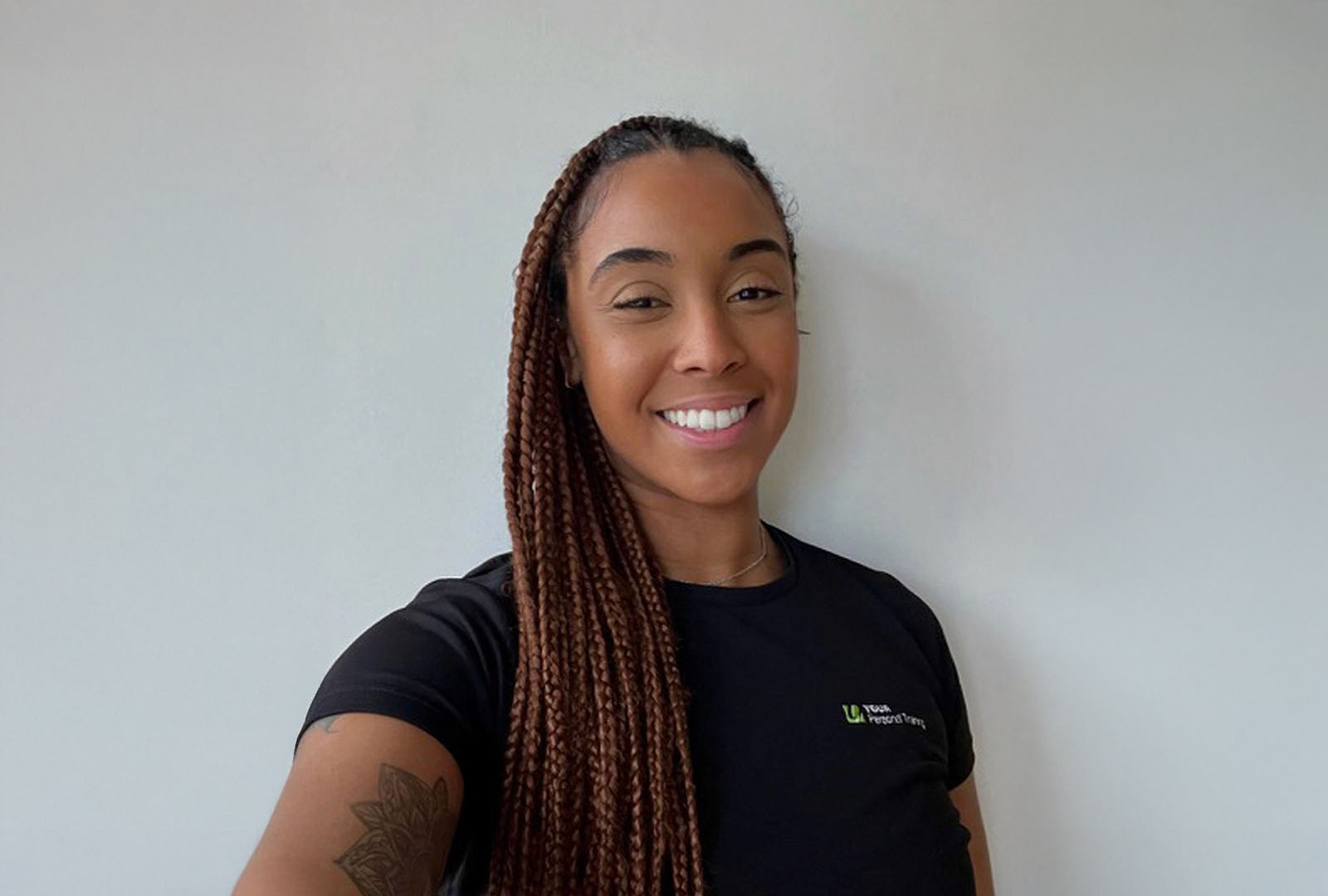 Close-up of lush, dark green leaves, some glossy and wet, against a muted background.