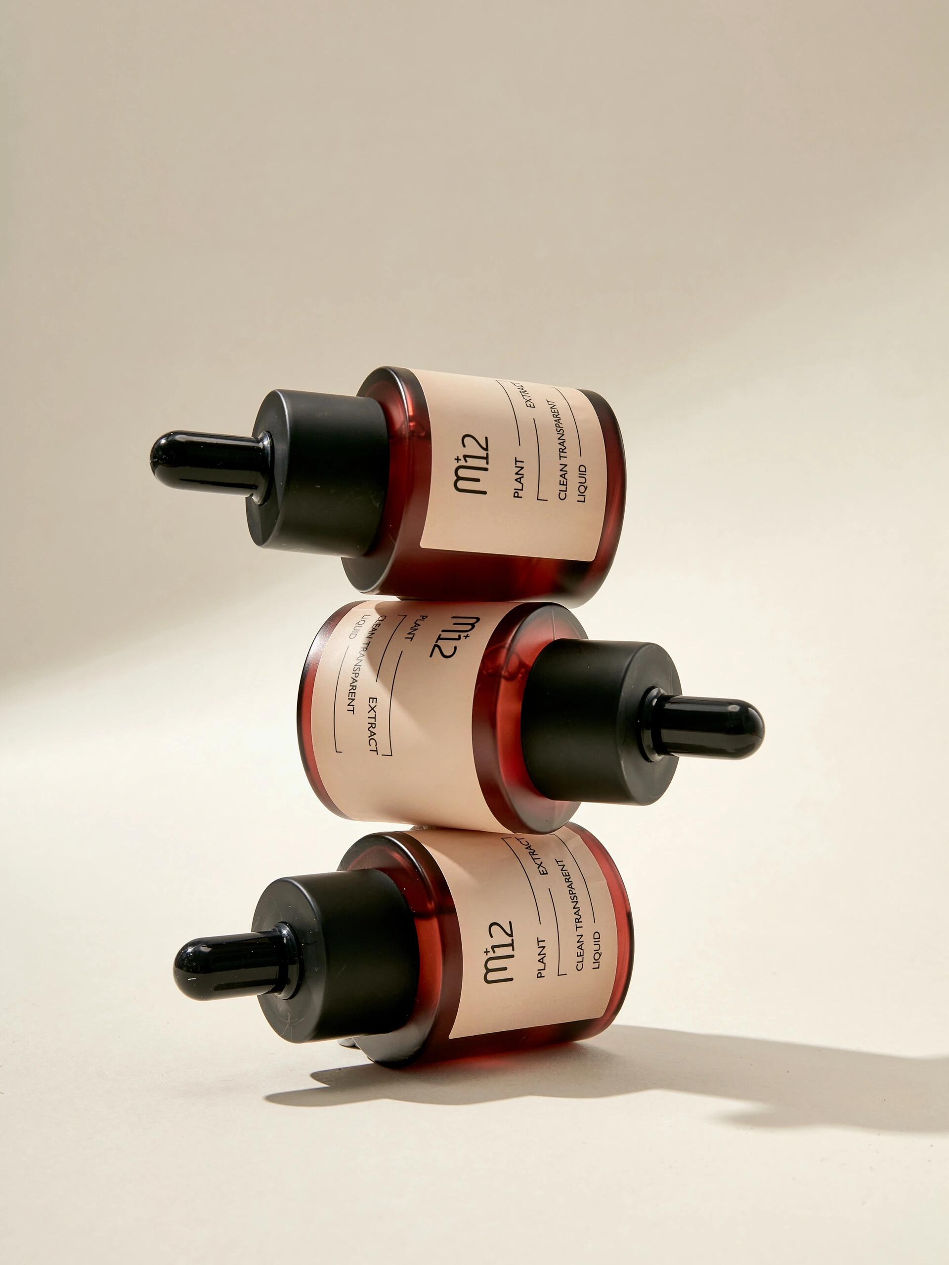 Skincare serum bottle stacking photography by Lefty Studio