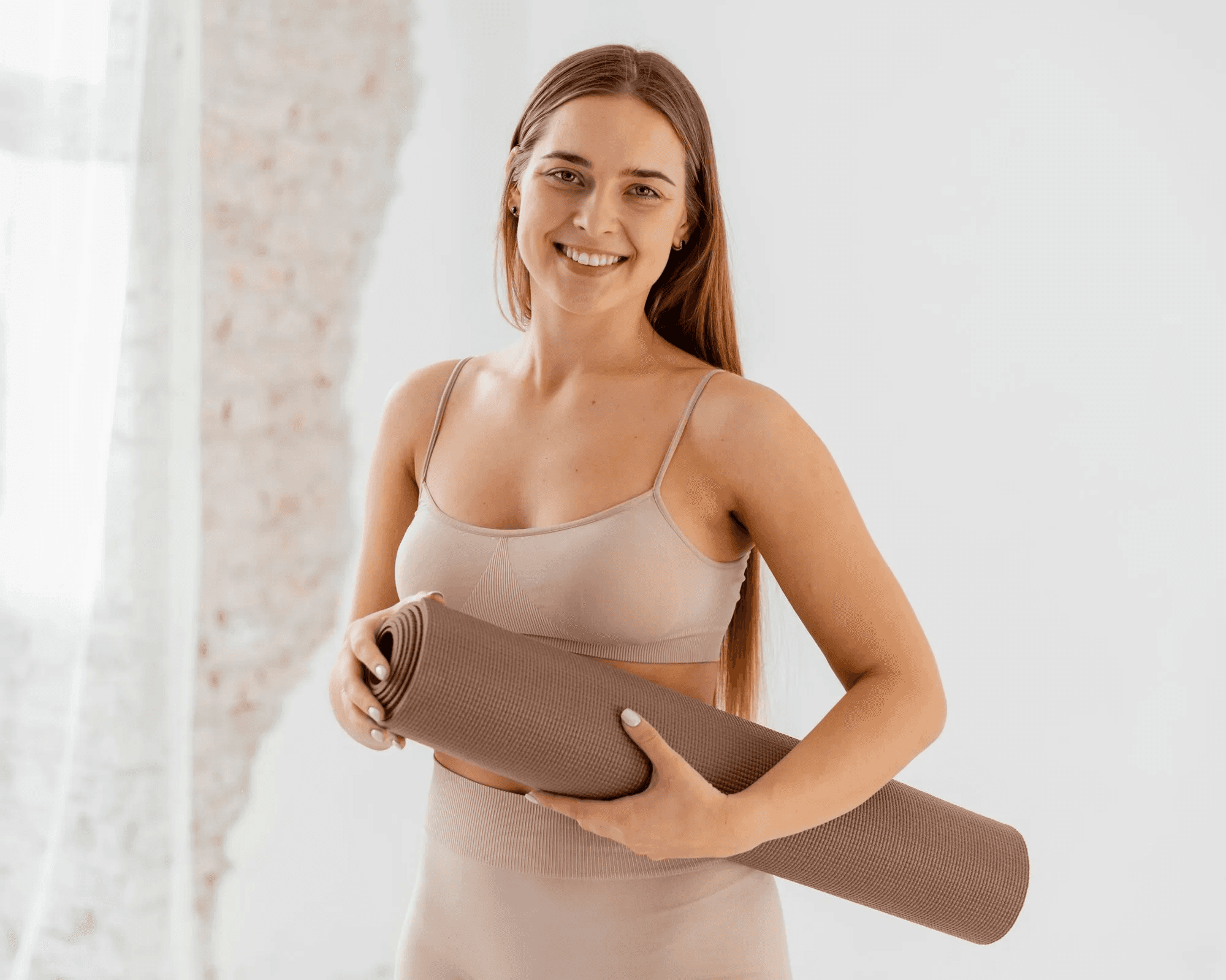 Woman holding the yoga mate in her hands