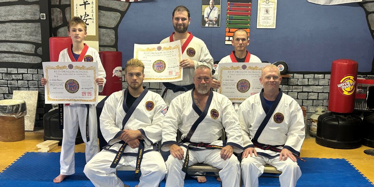 Men posing with their certificates, showcasing their accomplishments in Tang Soo Do and Hapkido at Redfield Martial Arts.