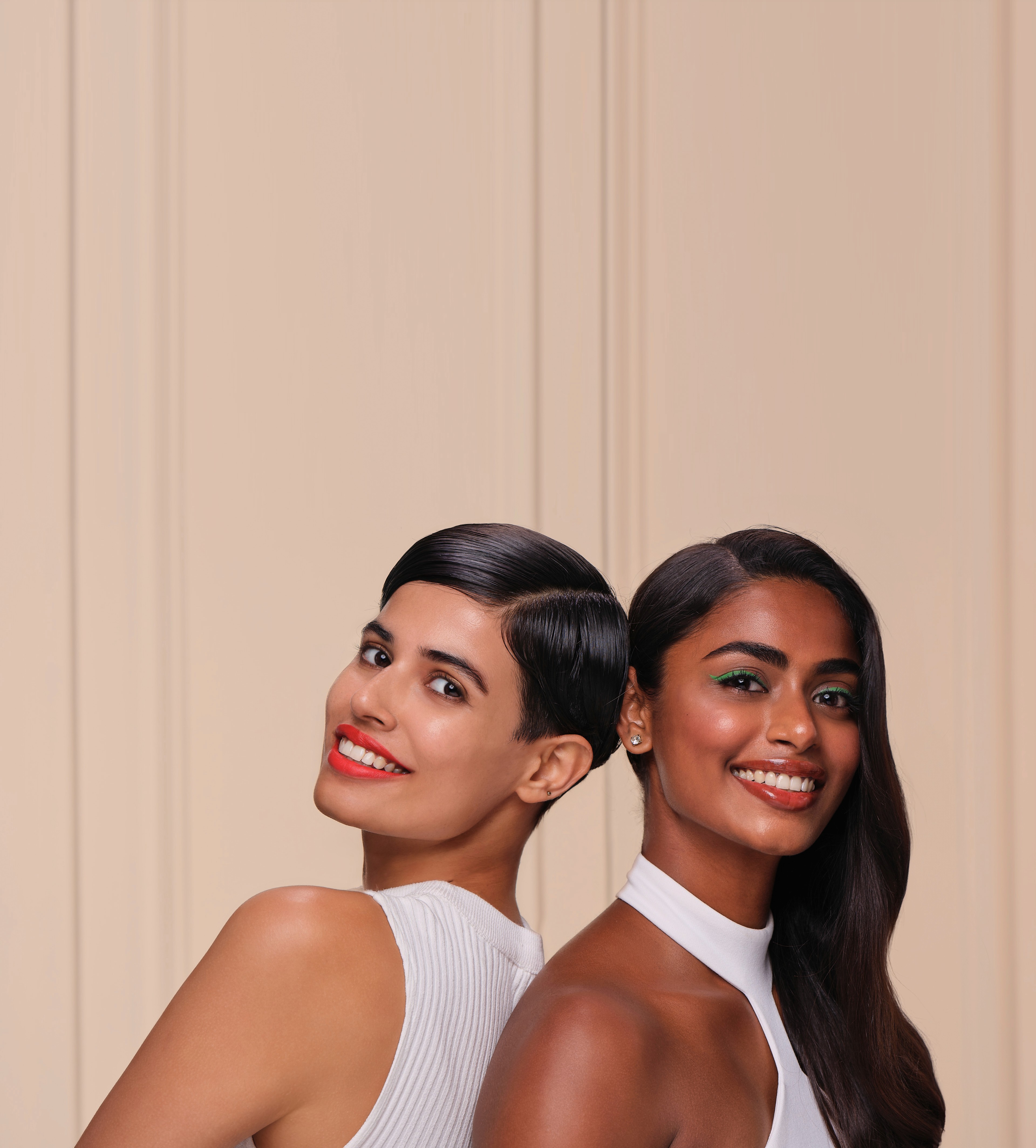 Group of friends smiling on a lively city street at night