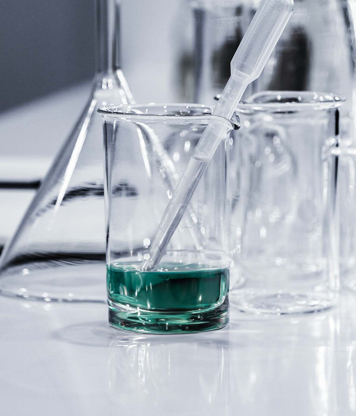 A science lab with teal liquid in a beaker