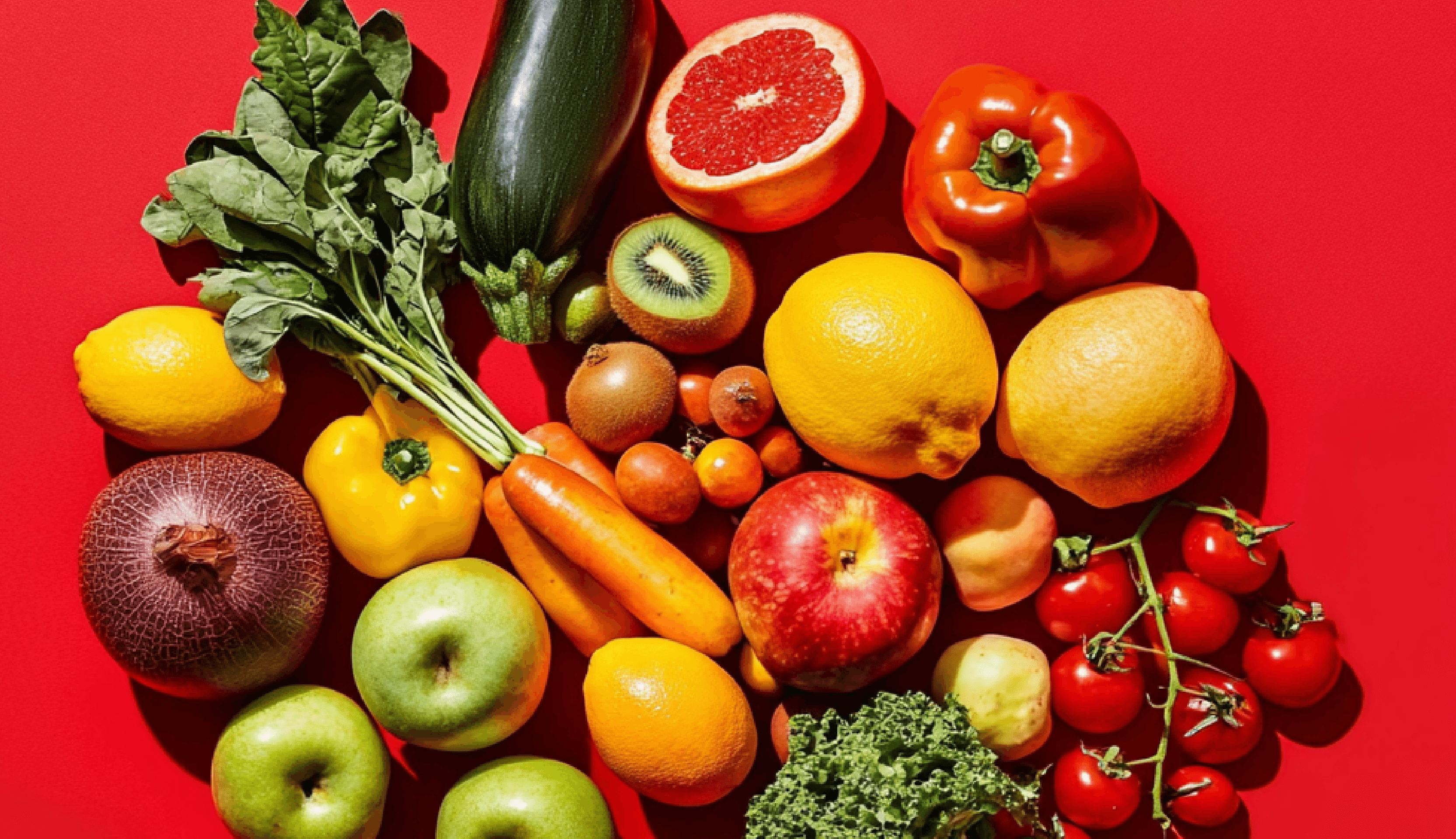 Fruit and vegetables on red background