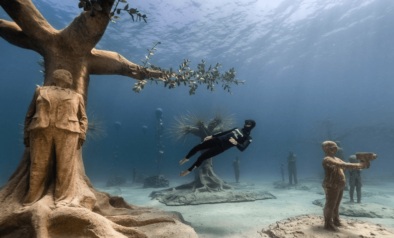 freediver meister swimming in underwater museum