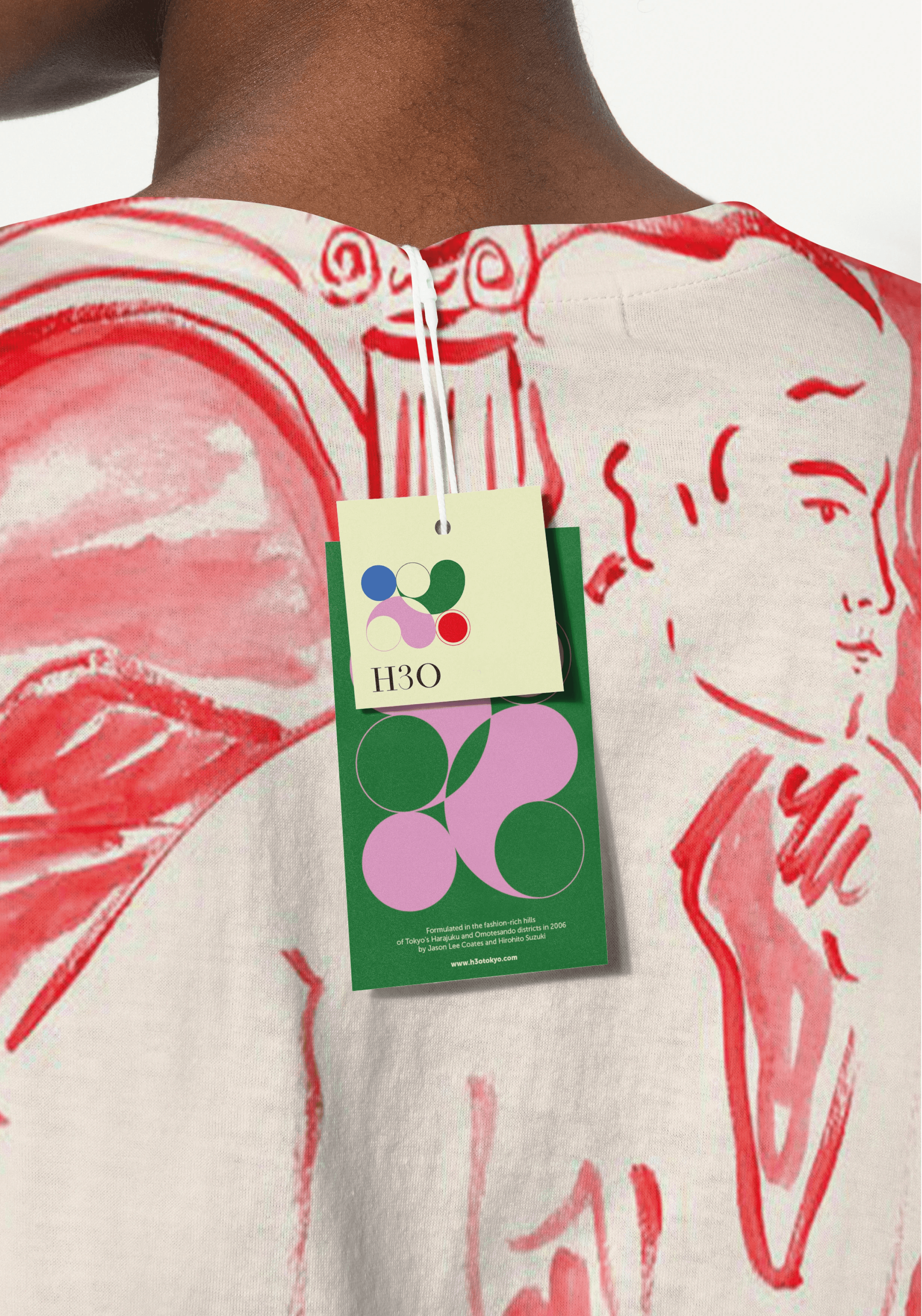 H3O branded card placed on a red illustrated fabric, highlighting the fashion oriented identity.