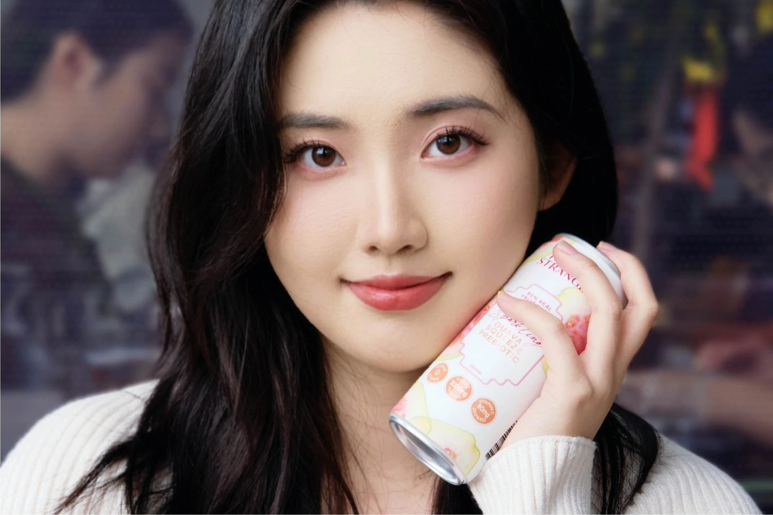 Chinese customer holding can of TOA Drink