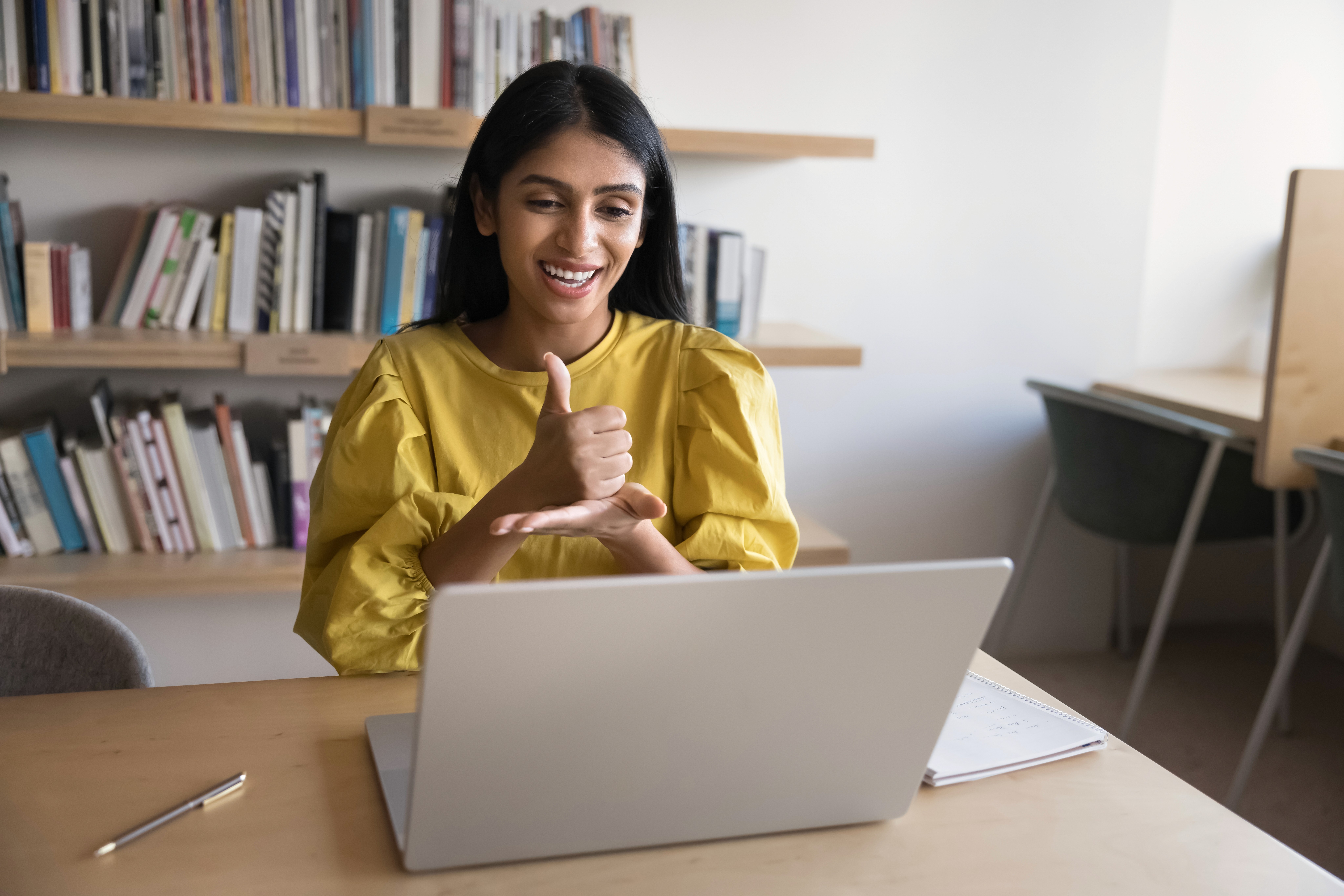 Interviewer using sign language to interview a deaf person over an online call