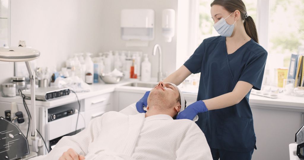 Dermatologist treating a patient in a clinic.