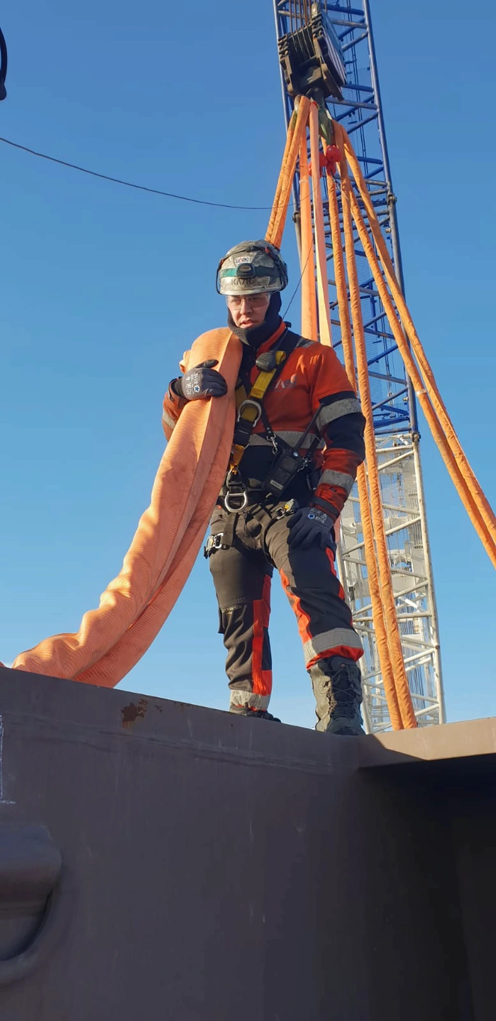 CASC rope access technician working at height with safety harness and lifting slings