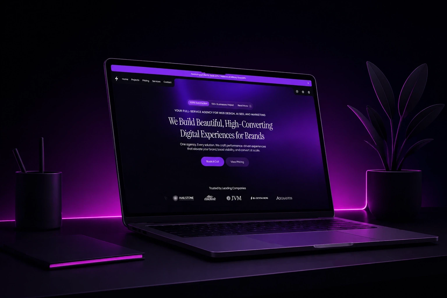 a laptop showing the nextus digital solutions website on a dark desk with a pink backlight