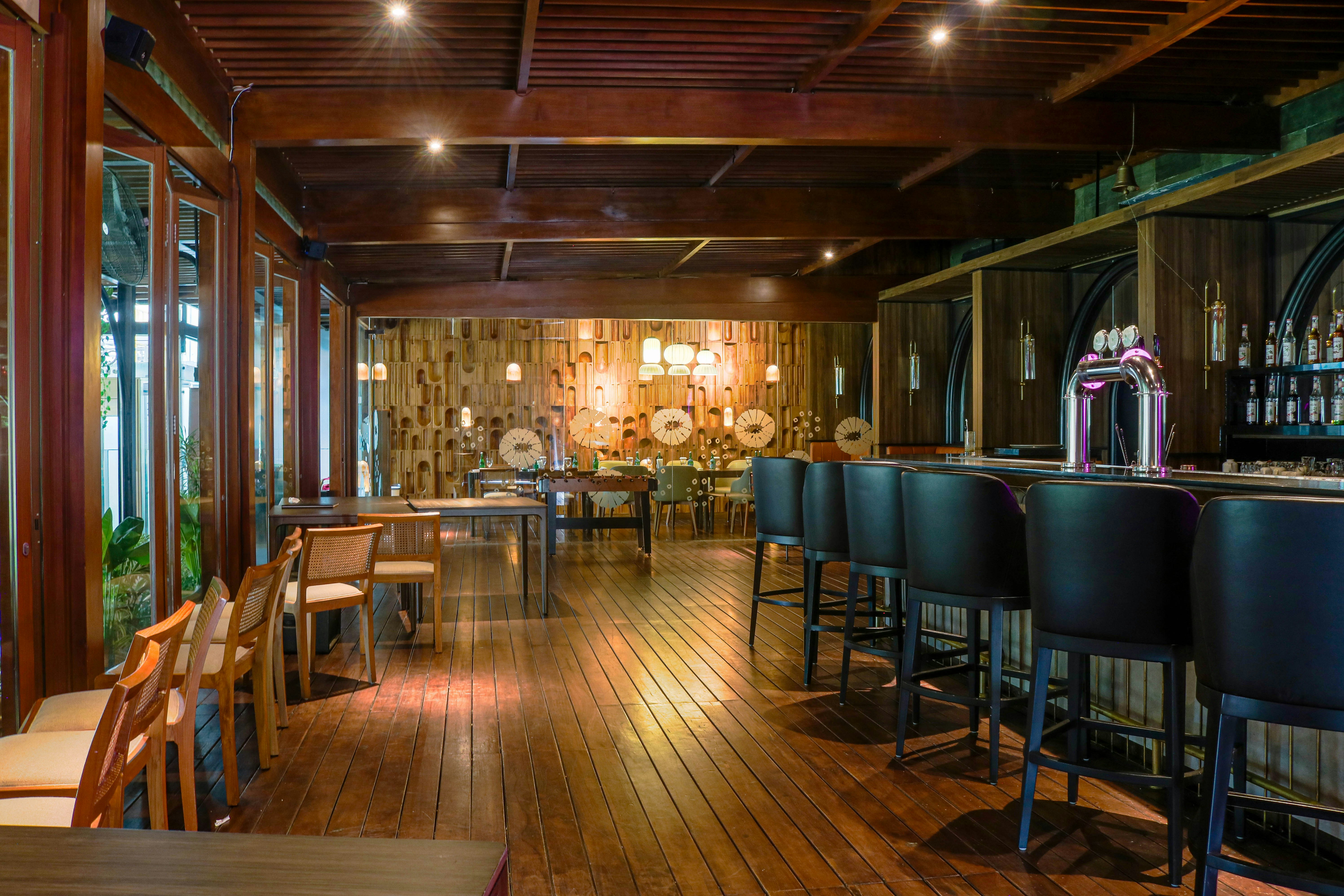 a restaurant with wooden floors and a bar