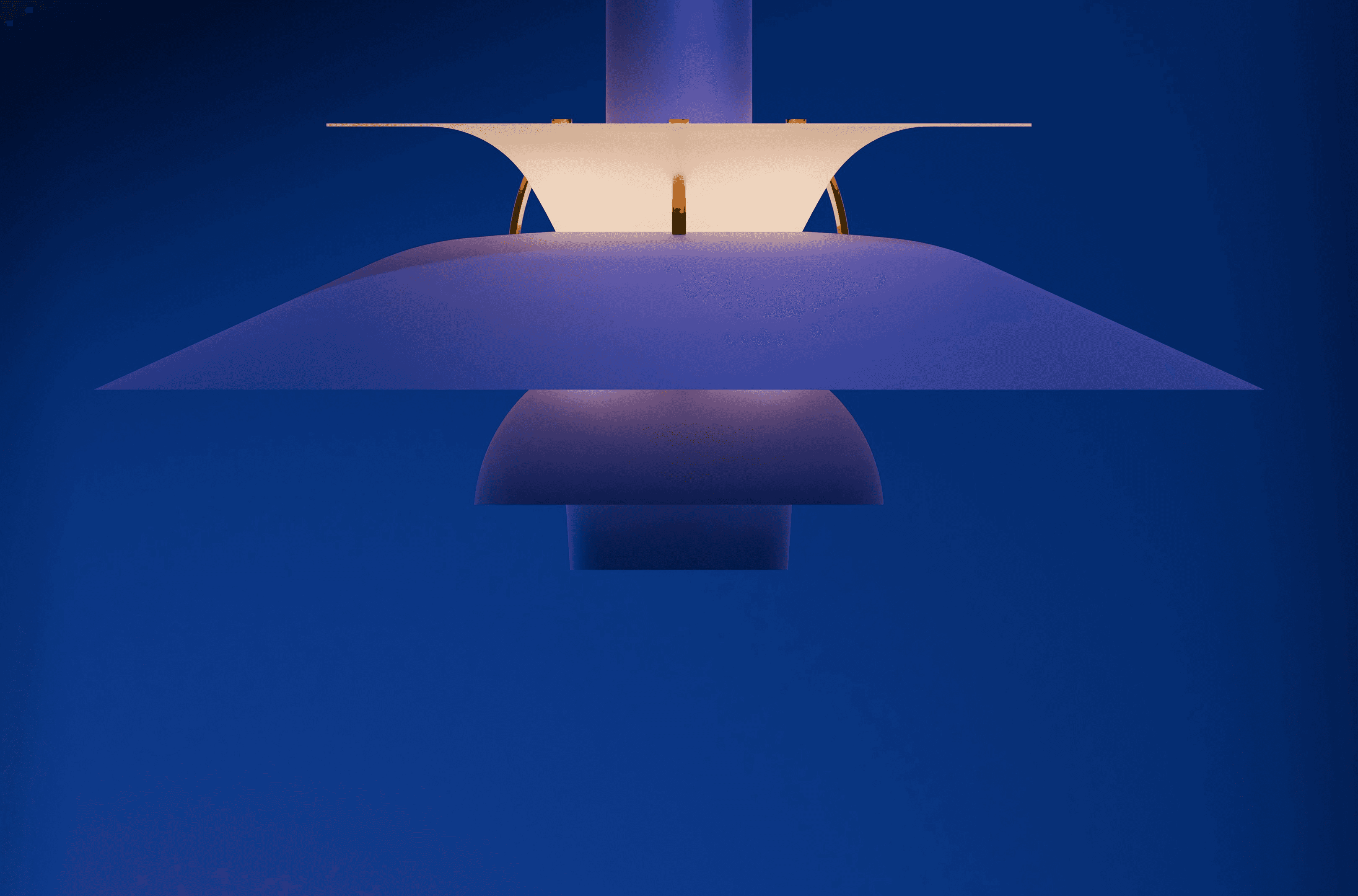 A modern blue pendant light illuminated against the blue.