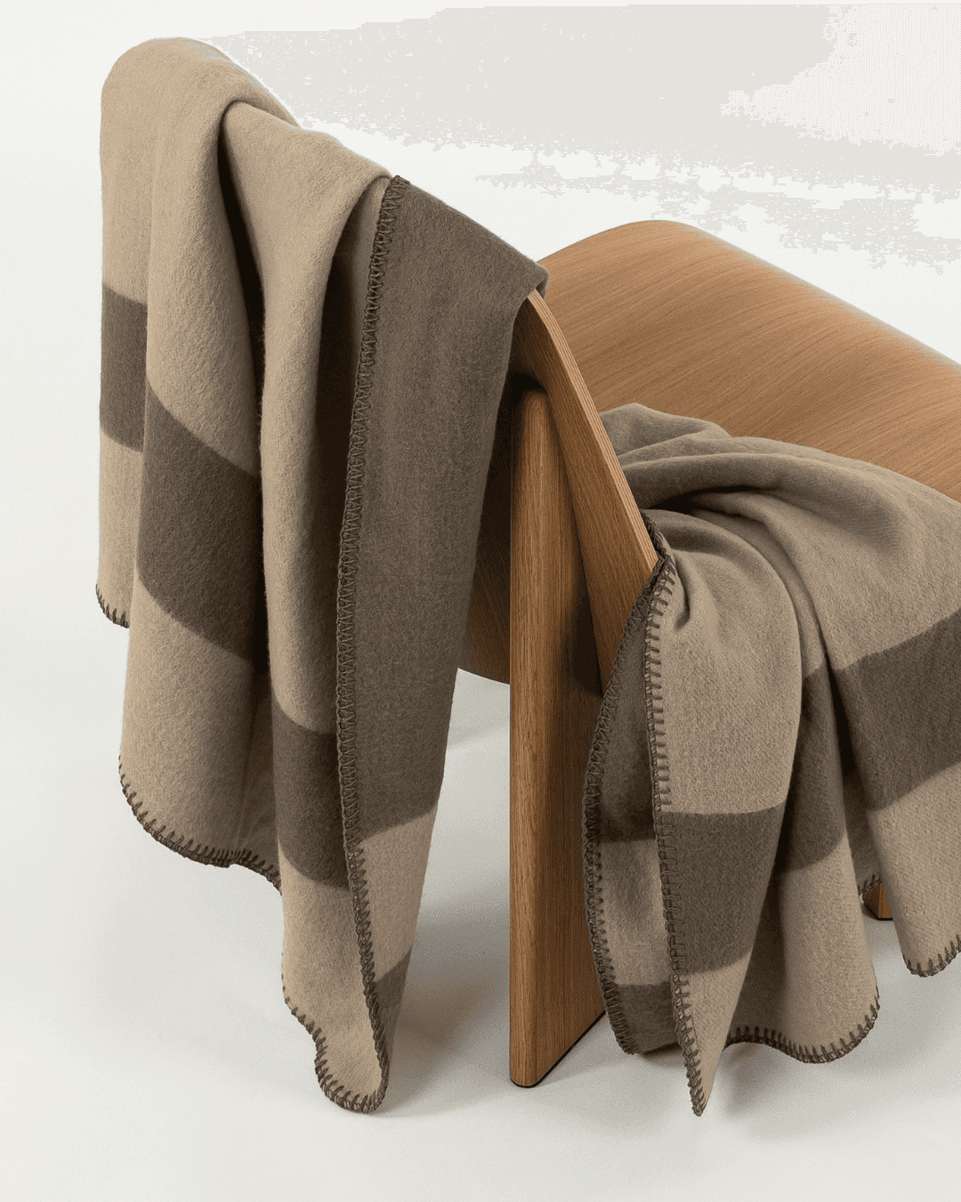 Merino wool blanket in clay/fungi draped over a wooden chair