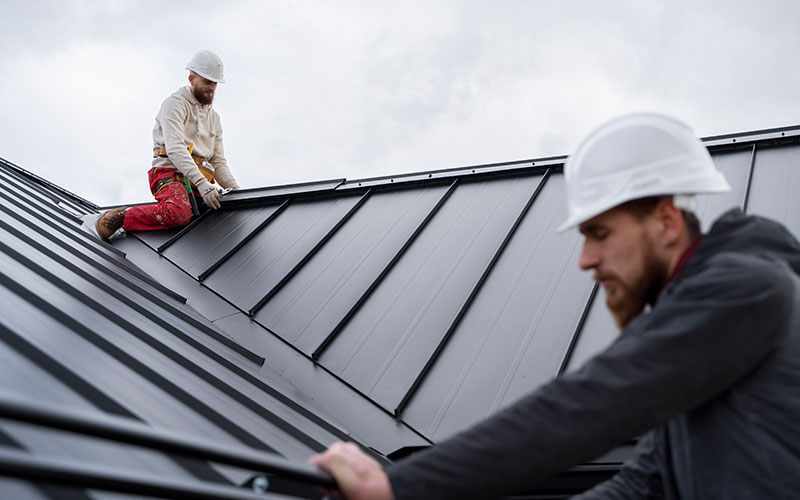 a kitchen with white cabinets and marble counter tops