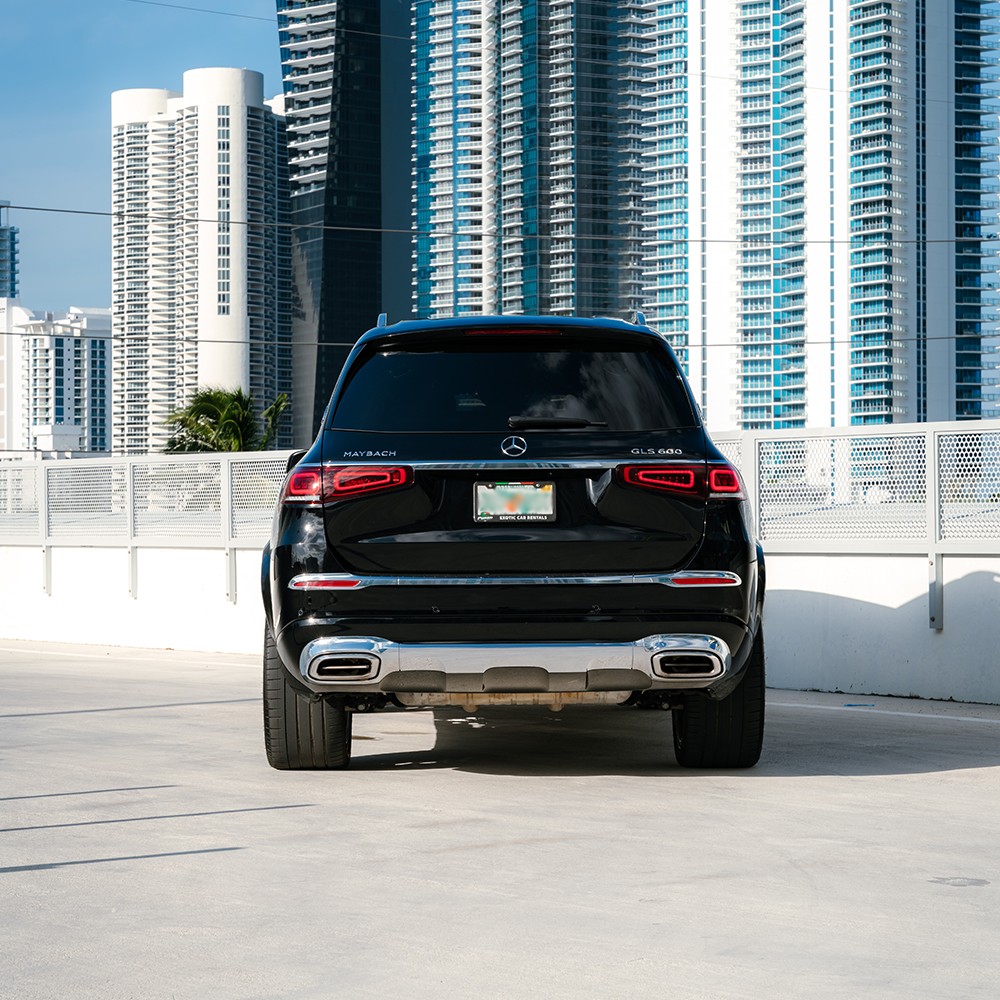 Rear view of a black Mercedes-Maybach GLS 600, highlighting its elegant taillights and premium chrome accents.