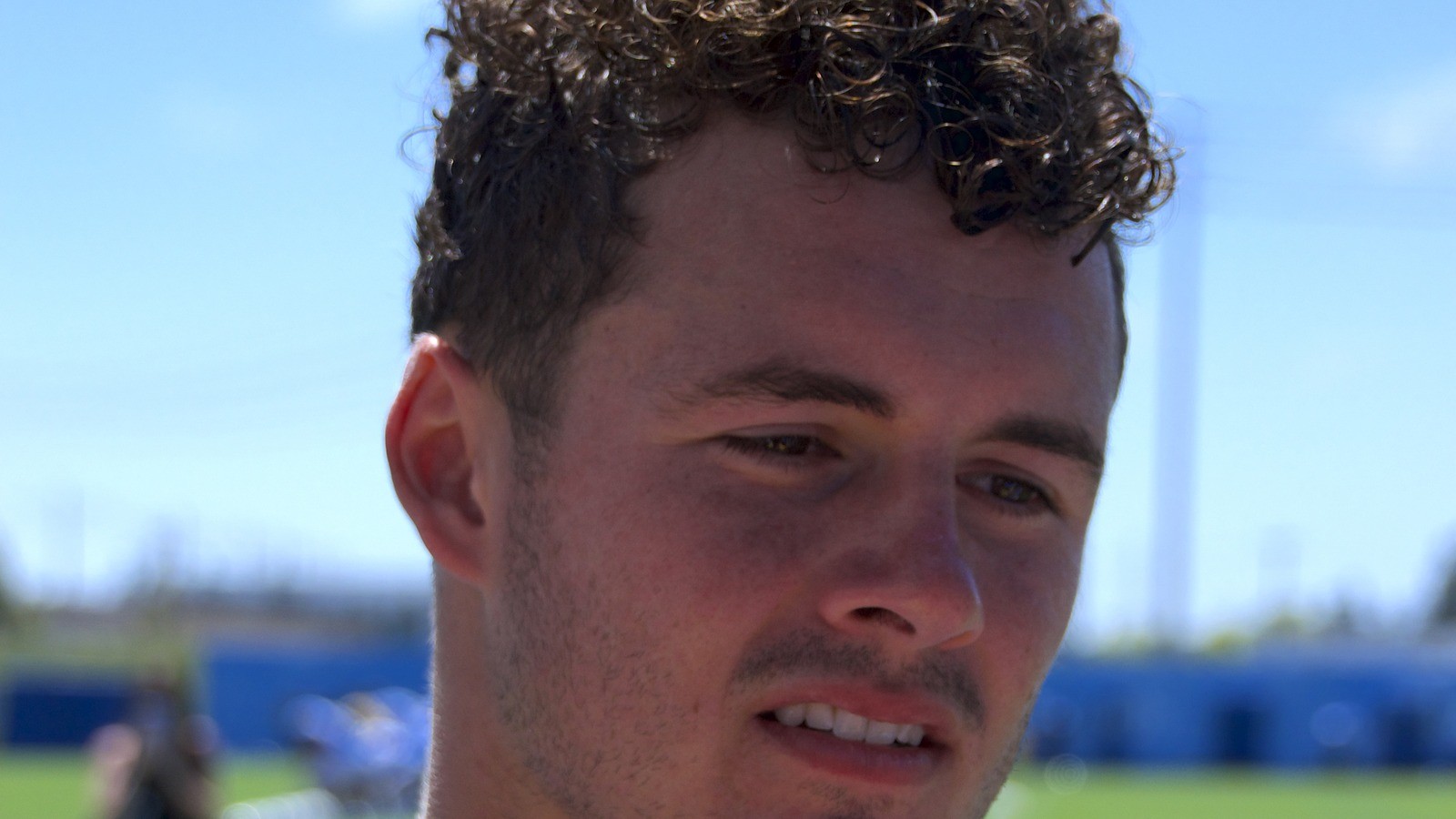 Close-up of Ladd McConkey outdoors with curly hair, face centered
