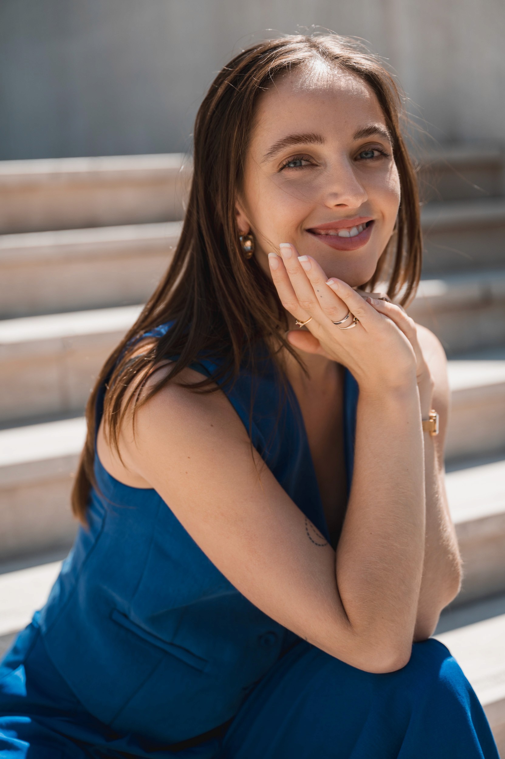 Woman in bathrobe holding champagne glass on bed.