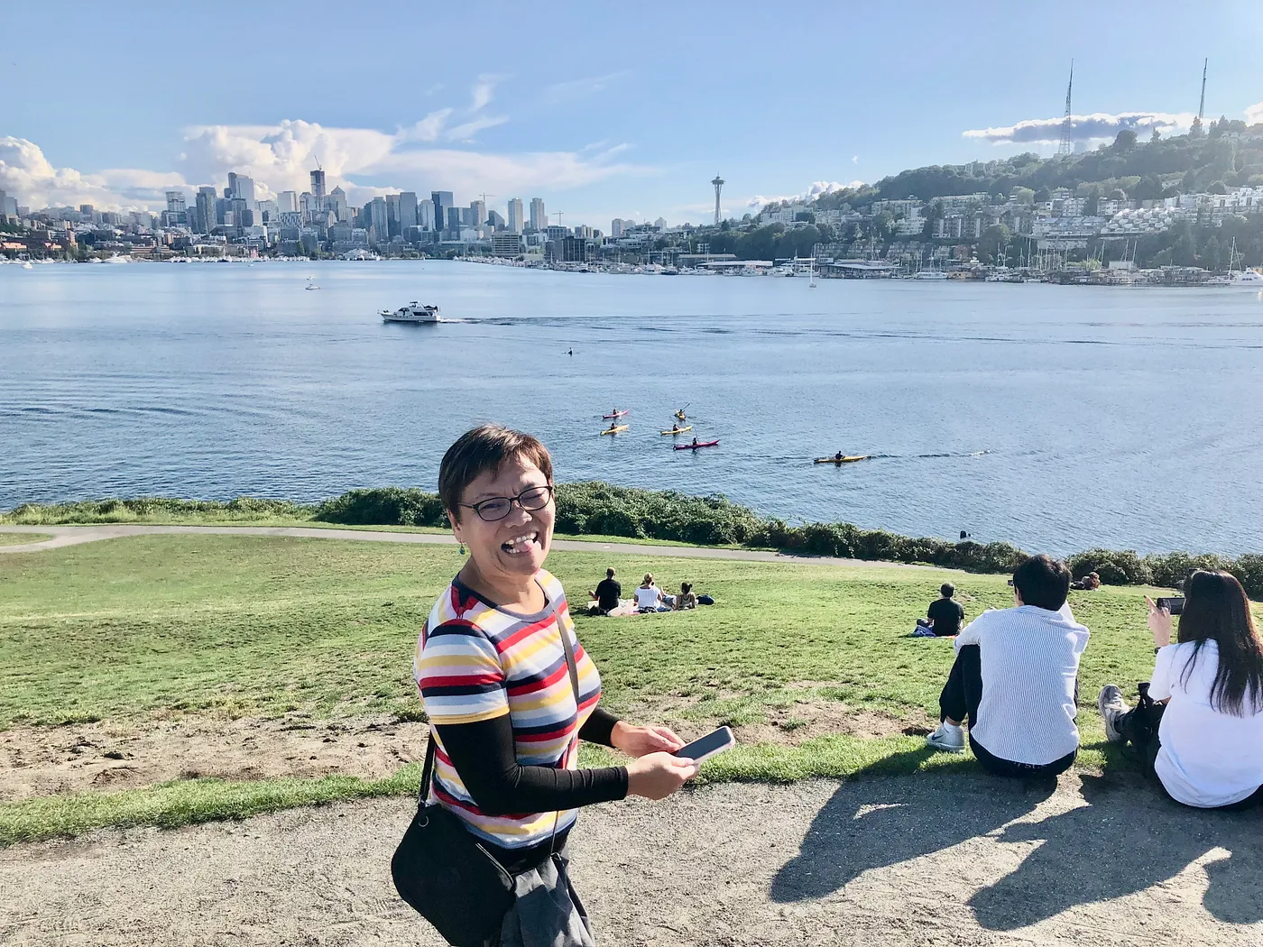 Mai standing in front of a lake and smiling