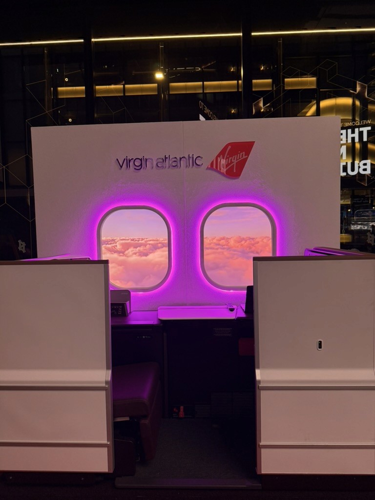Custom Virgin Atlantic aircraft cabin installation with illuminated windows created for the Visit California activation.