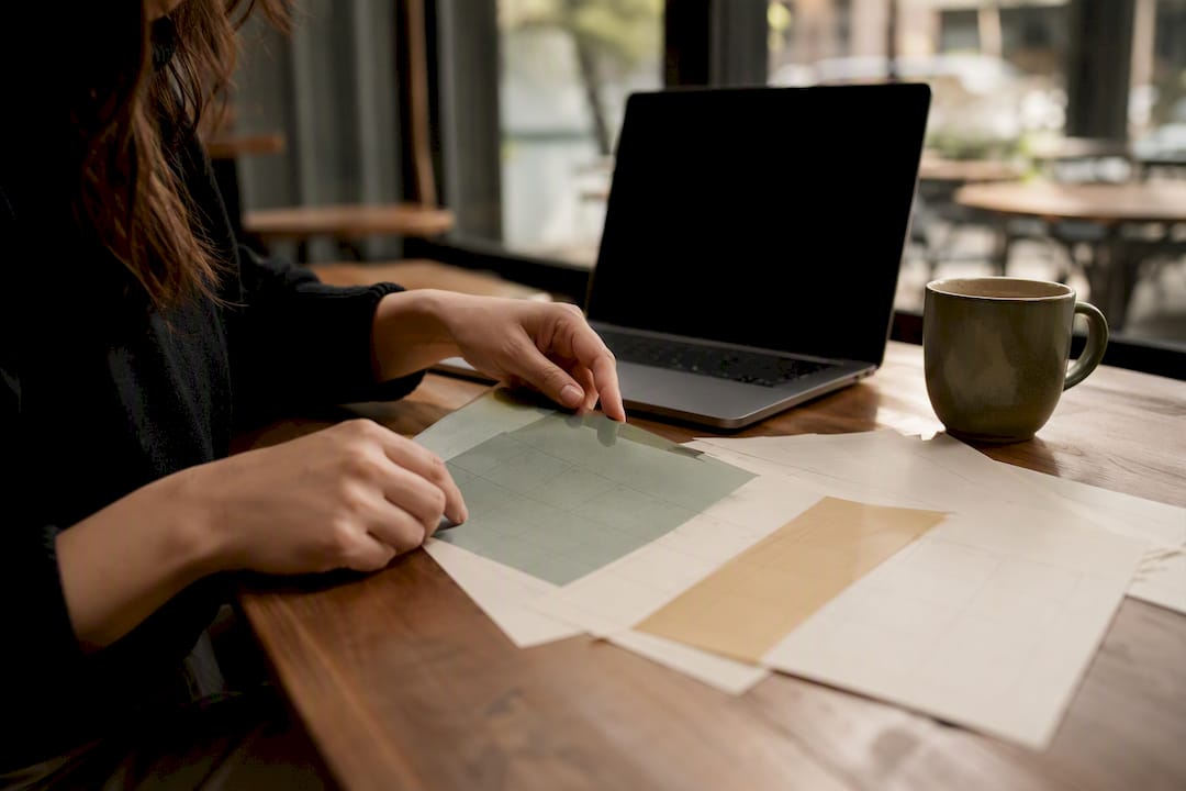 Hands aligning marketing calendar sheets