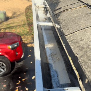 Interior of a spotless rain gutter channel after debris removal service in Kansas City.