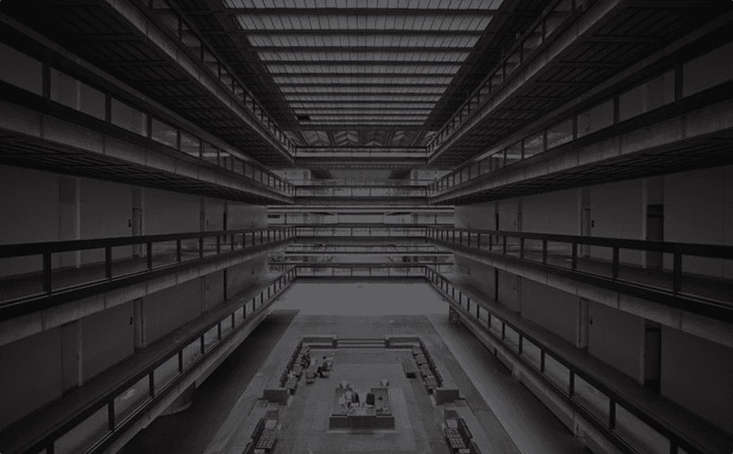 a person standing in front of a building with a cell phone