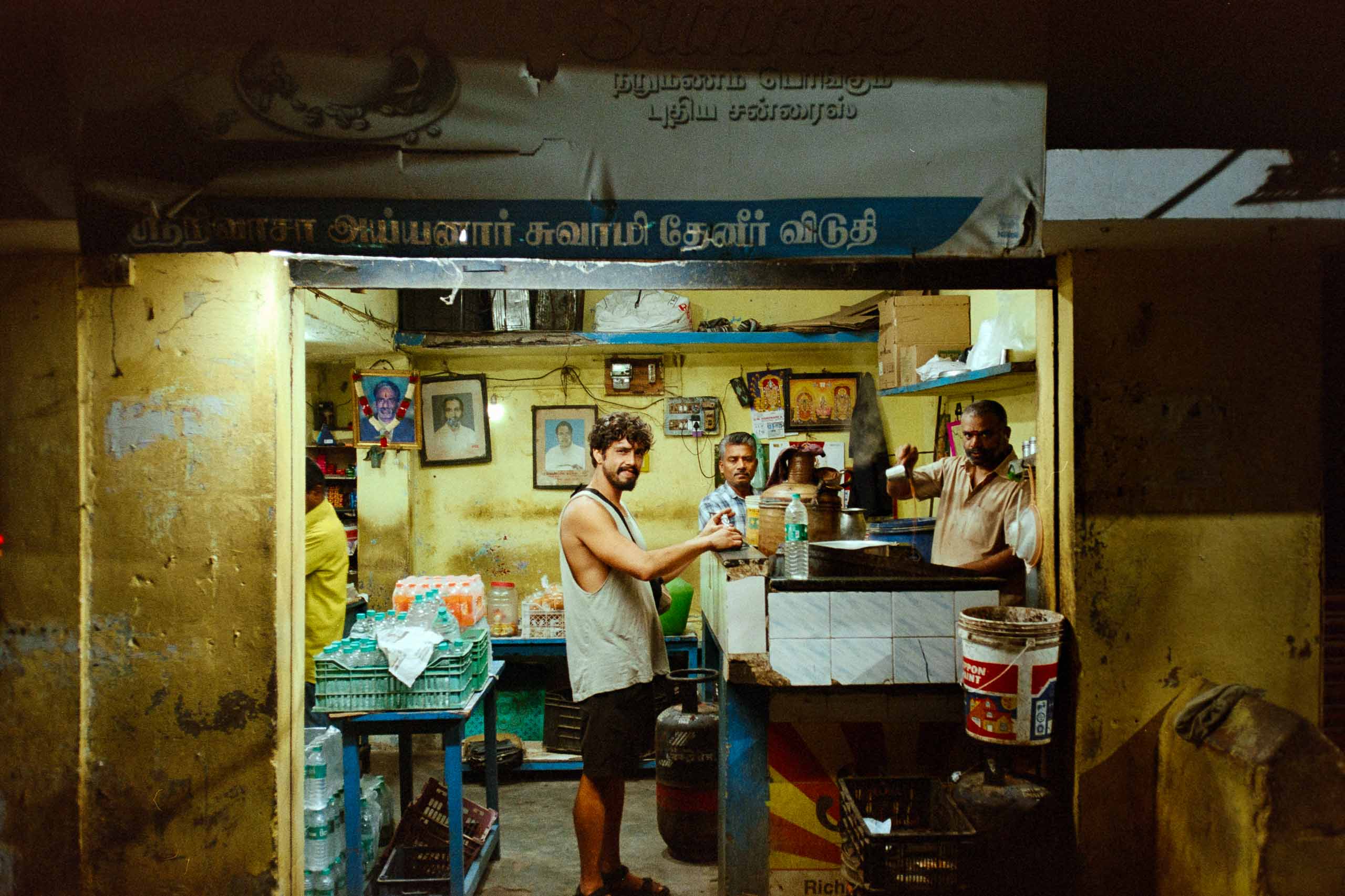 A person stands in a sandstone cave.