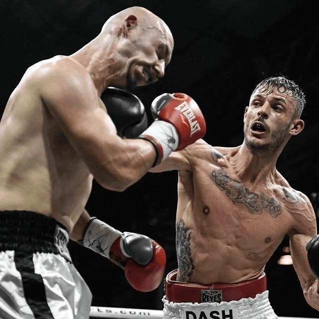 Danilo Dash Creati landing a punch on an opponent in a professional match.