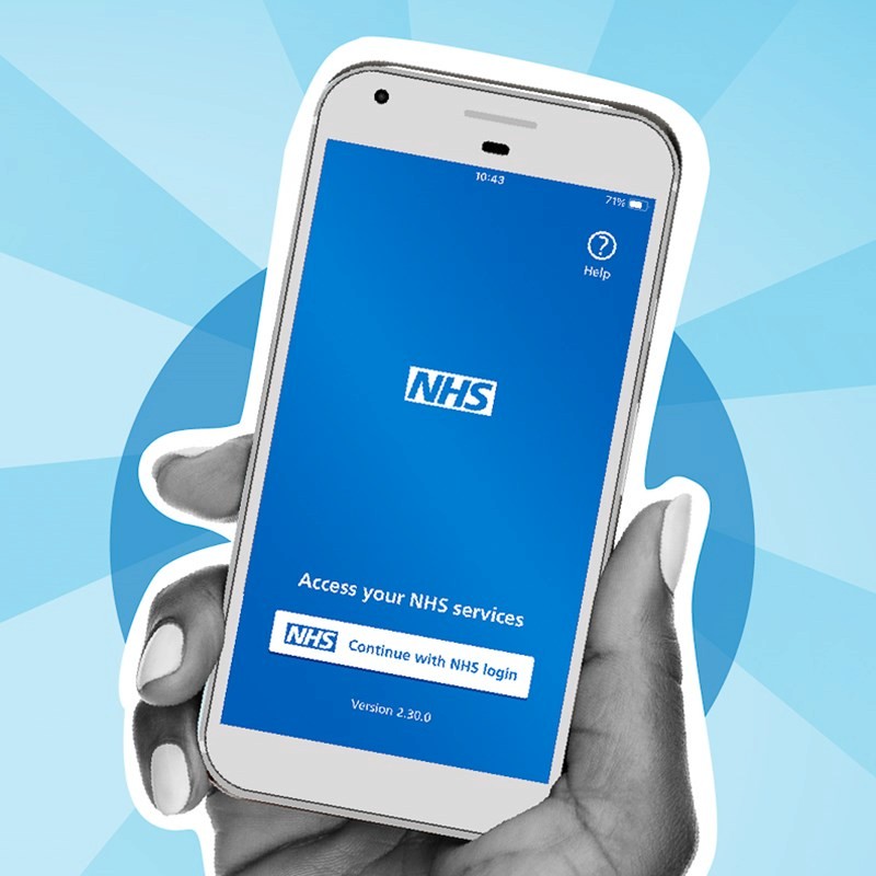 Photo of a hand clasping a smart phone with the NHS england app on the screen