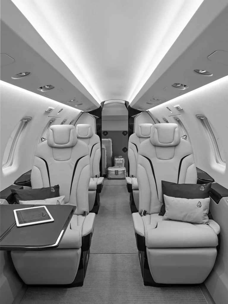 Luxury private jet interior with rows of comfortable leather seats and mood lighting