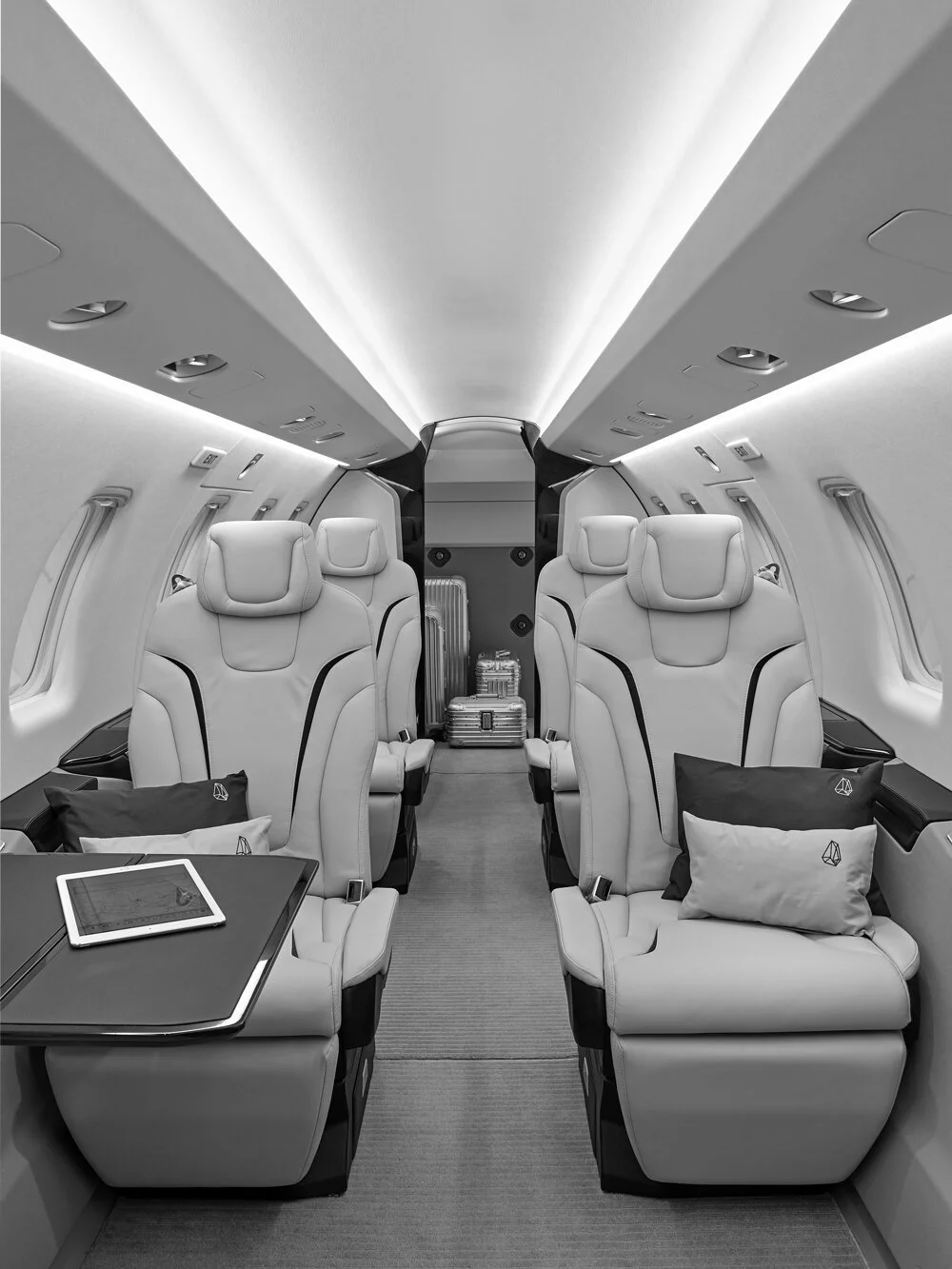 Luxury private jet interior with rows of comfortable leather seats and mood lighting