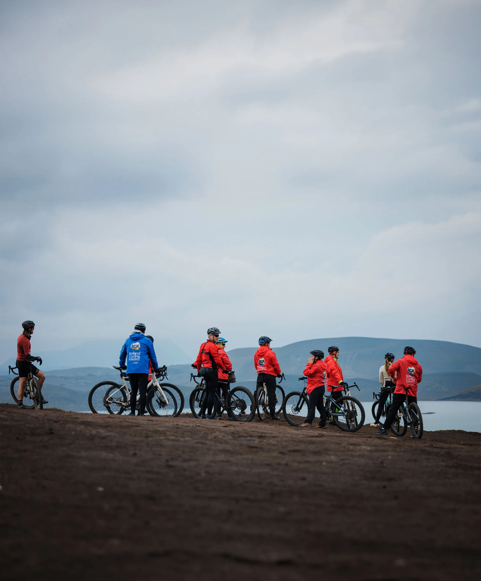 dramatic clouds over a group of cyclists standing by their bikes