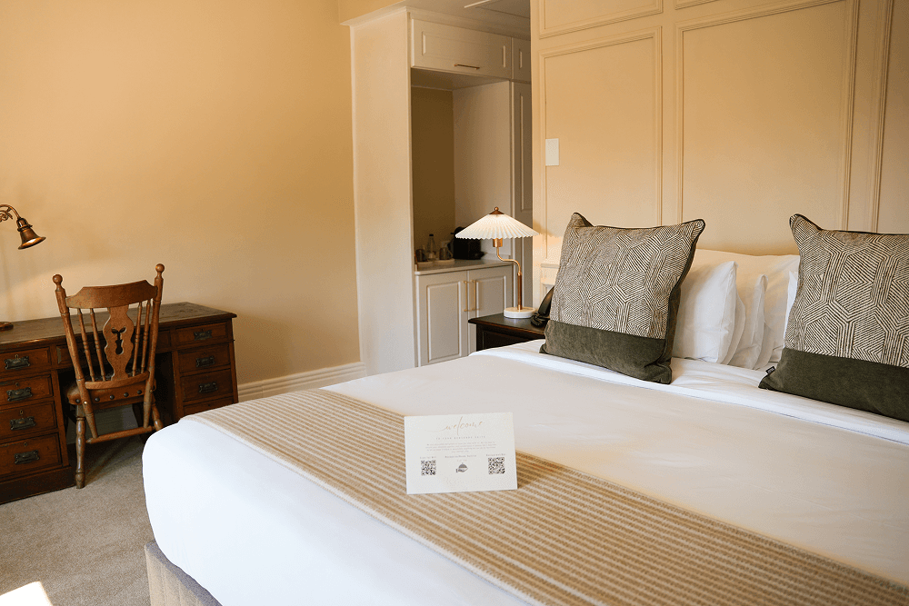 Redlands Hotel Deluxe Room with king-size bed, luxury bathroom, and modern amenities.