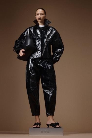Image may contain Clothing Coat Adult Person Jacket Accessories Bag Handbag Raincoat Face and Head