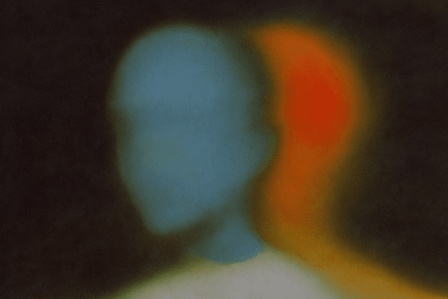 Abstract blurred profile of a human head in cool blue tones with a warm orange glow behind