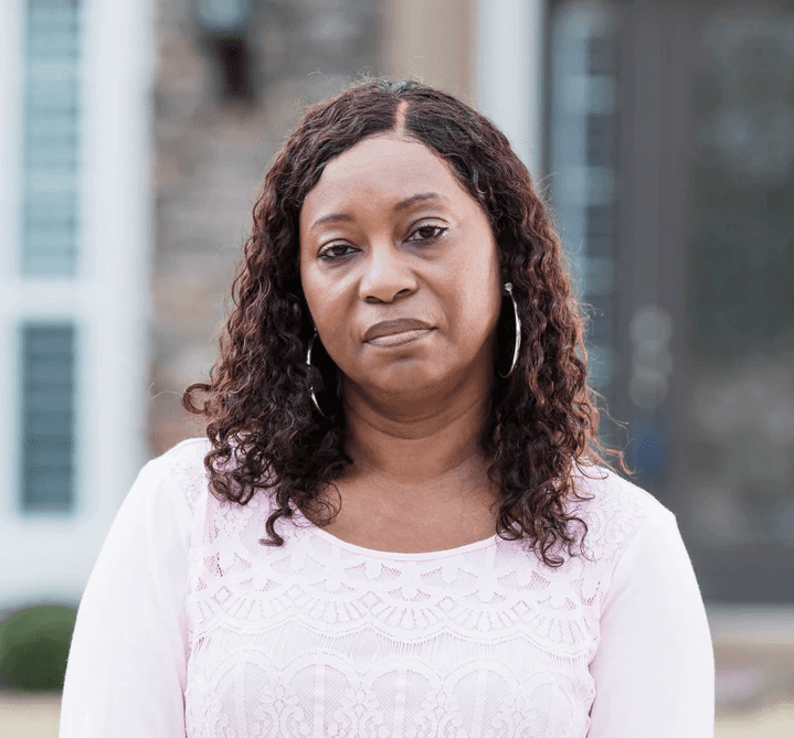 photo of a middle-aged woman standing outdoors