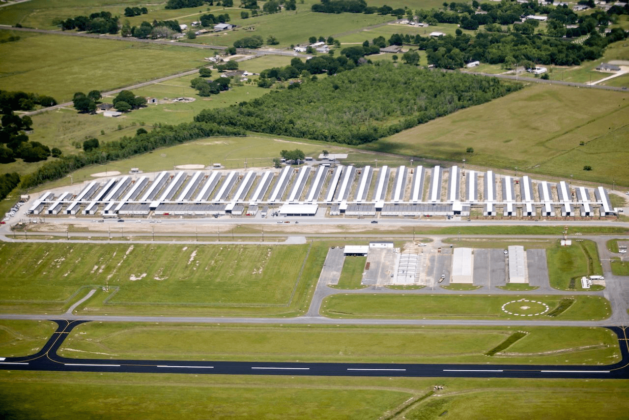 Wide aerial view of Moss Lake Village showing the scale of the housing site.