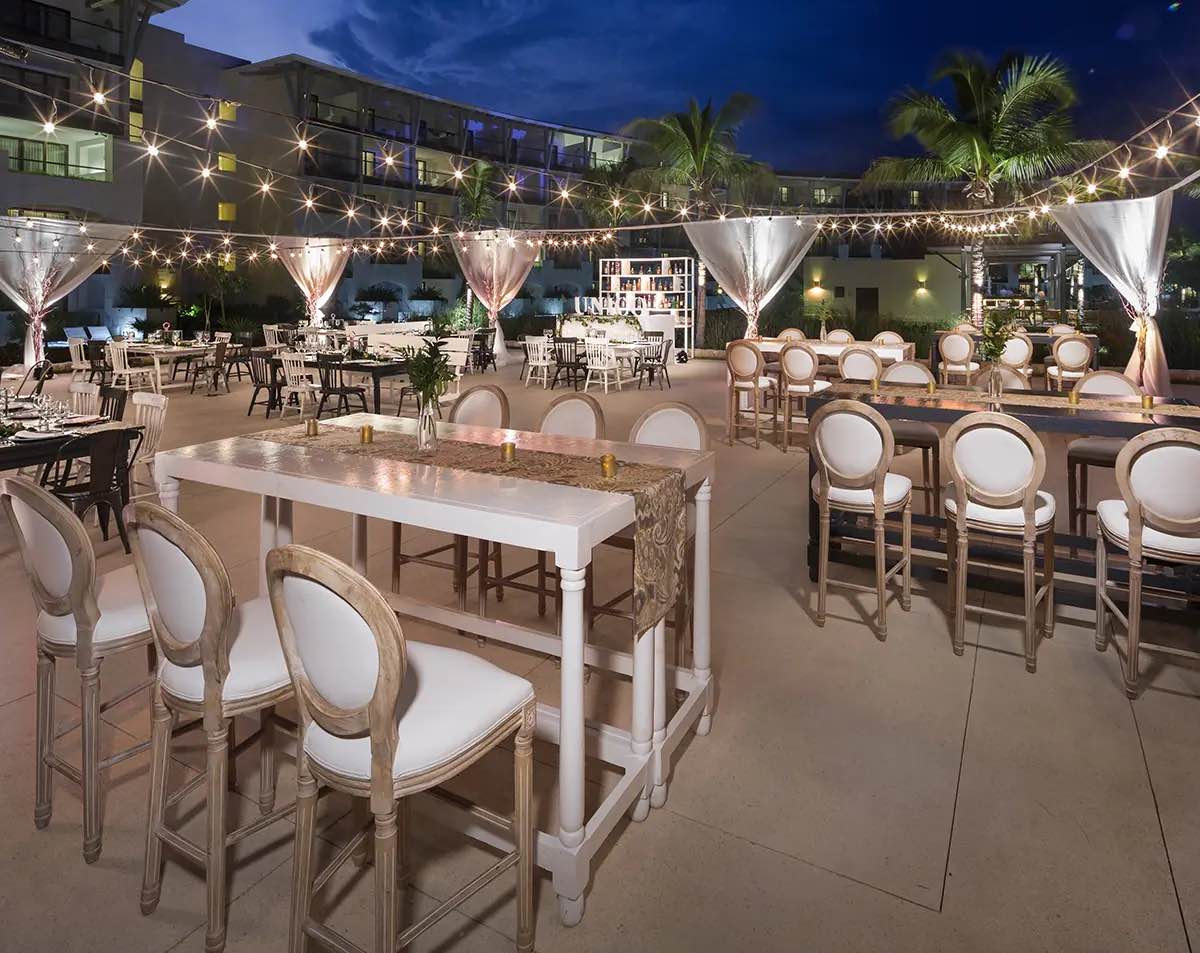 An evening event set up outdoors under string lights.