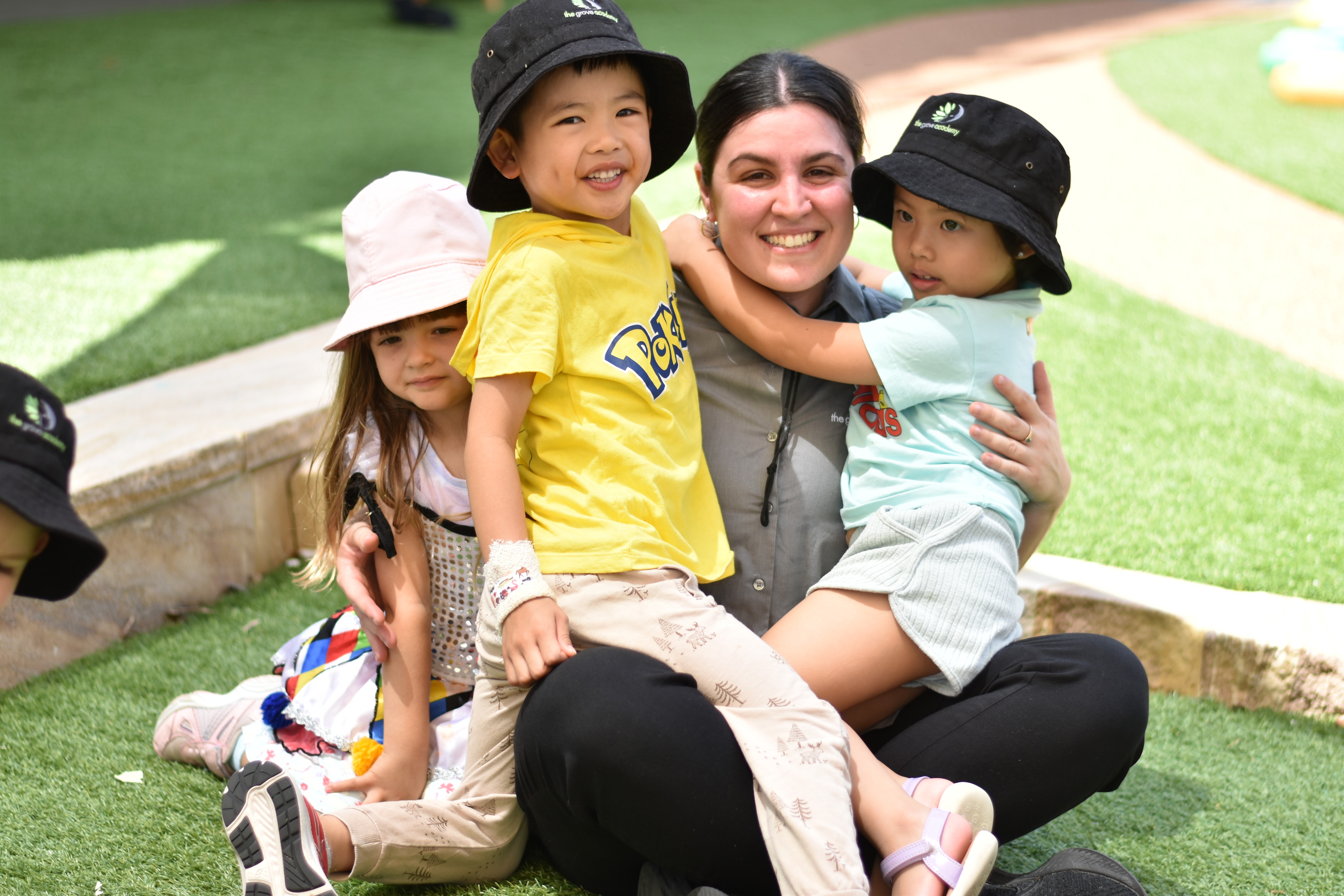 Close-up of a dark green leaf showing its textured surface and central vein against a muted background.