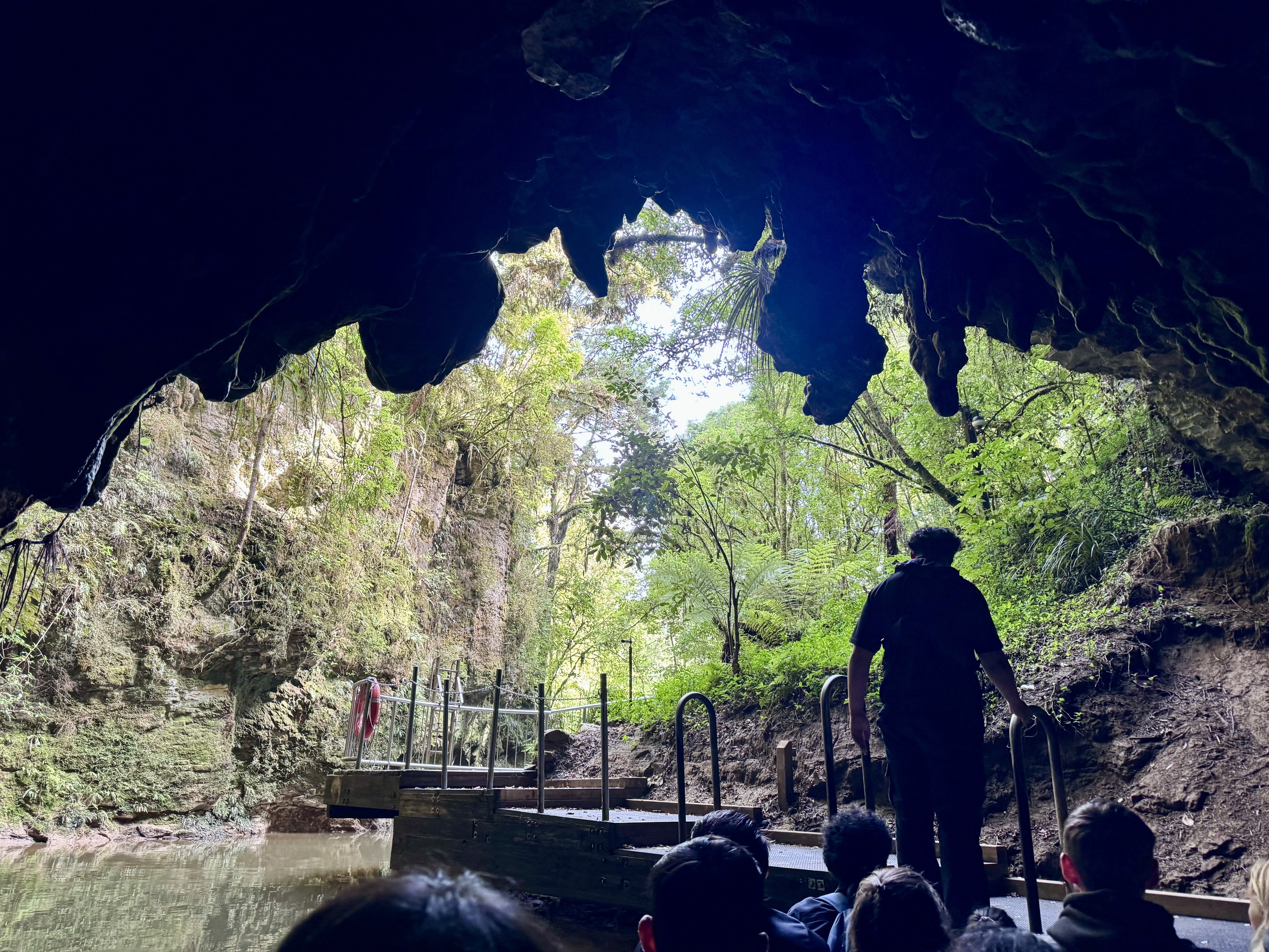 The tour boat approaching the exit of the Waitomo caves