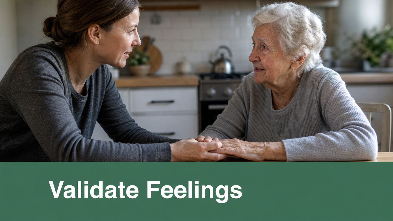 A caregiver compassionately holds the hands of an elderly woman during a supportive conversation in a kitchen.