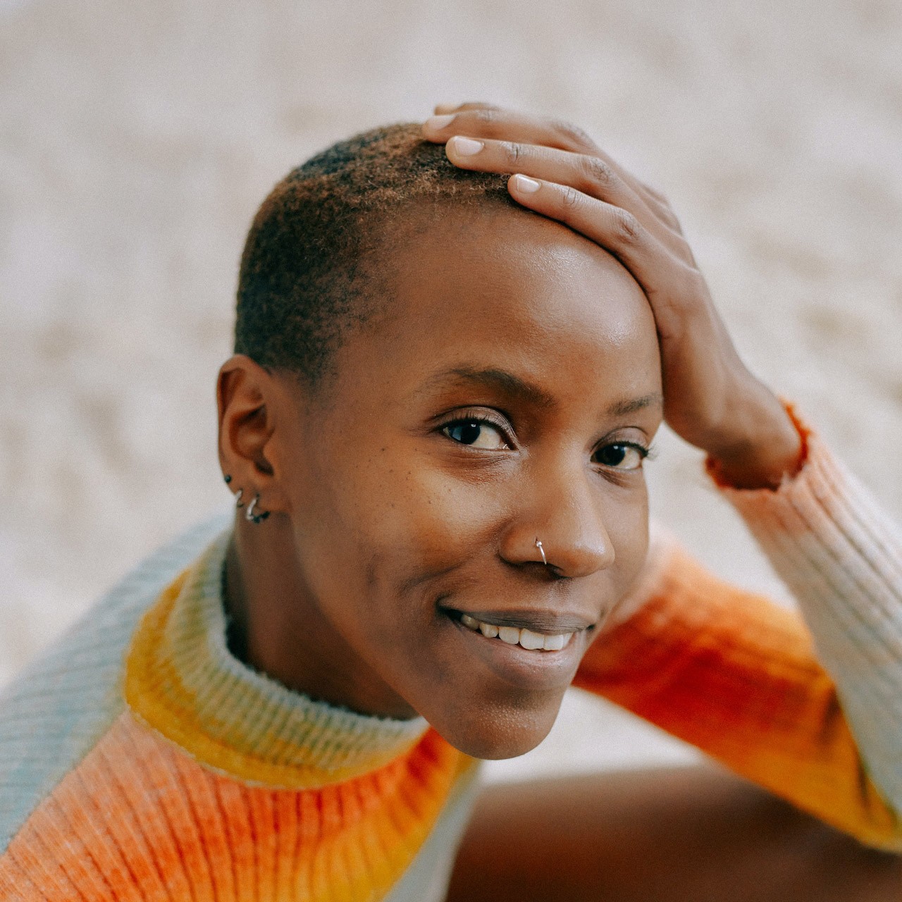 Woman smiling holding her head