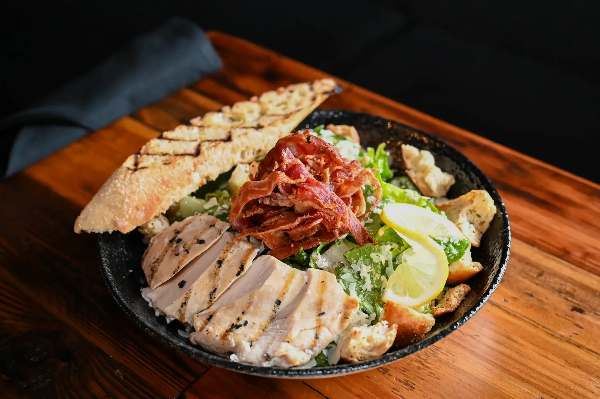 A chicken ceasar salad and bread