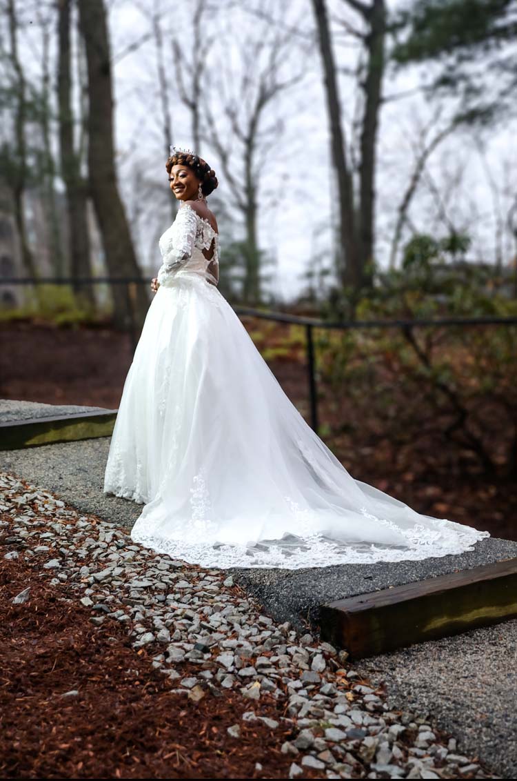 Bride standing outdoors on a wooded path
