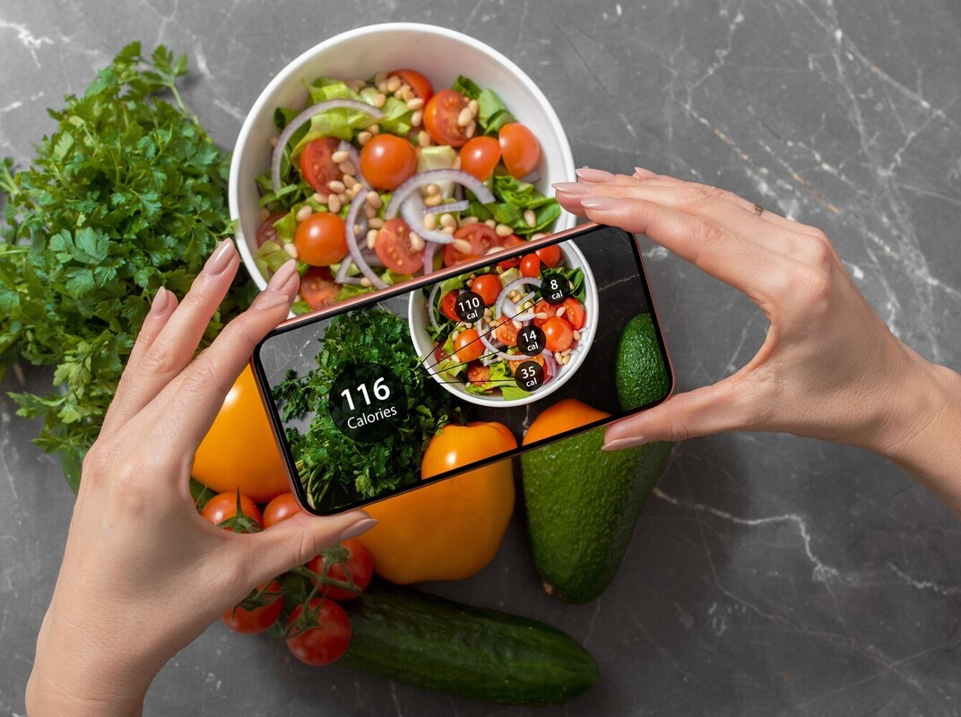 woman taking photo of a healthy meal to show healthy calories that can support walking everyday to lose weight