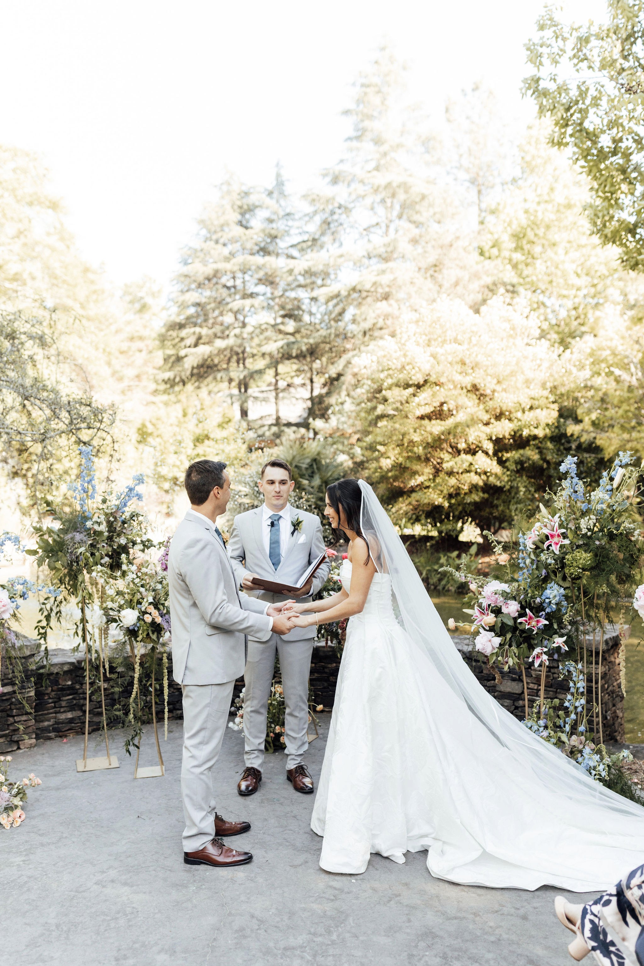 Bride and groom holding hands during their vow exchange at Shiloh Gardens.