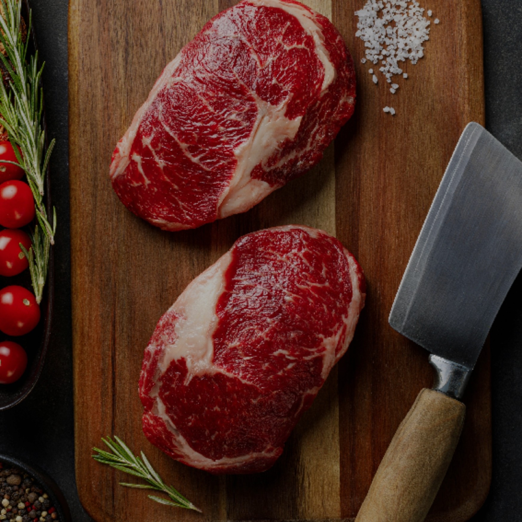 a couple of raw meat on a cutting board