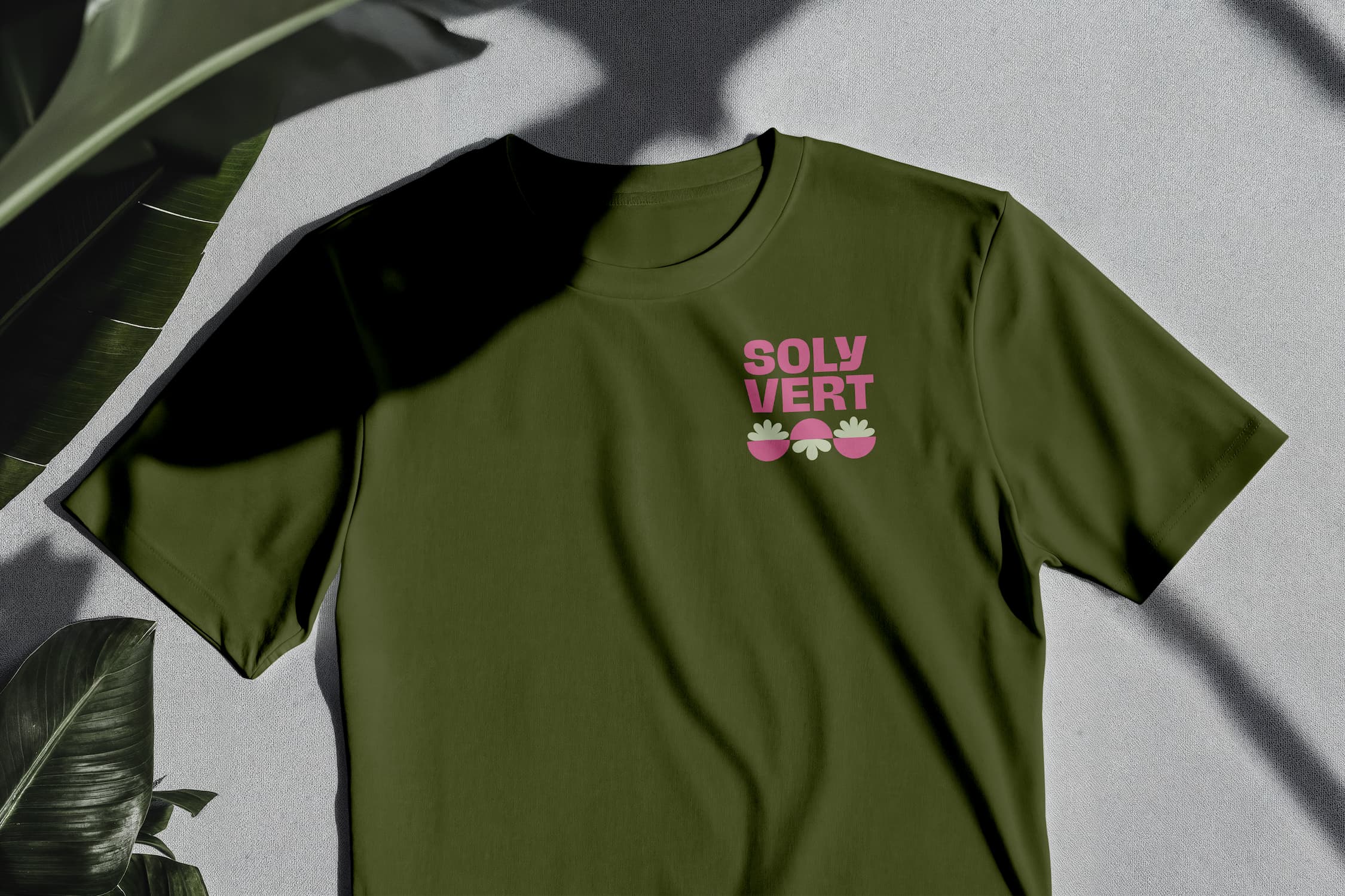 Green  t-shirt on white surface with Solyvert logo. 
