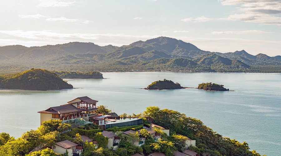  A forested ridge above the Pacific, villas tucked in, the islands just offshore.